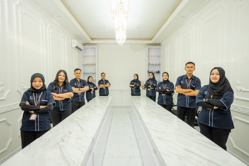 The whole team lined up in a long meeting room — Company Profile, PT Dwi Jaya Cosmedika