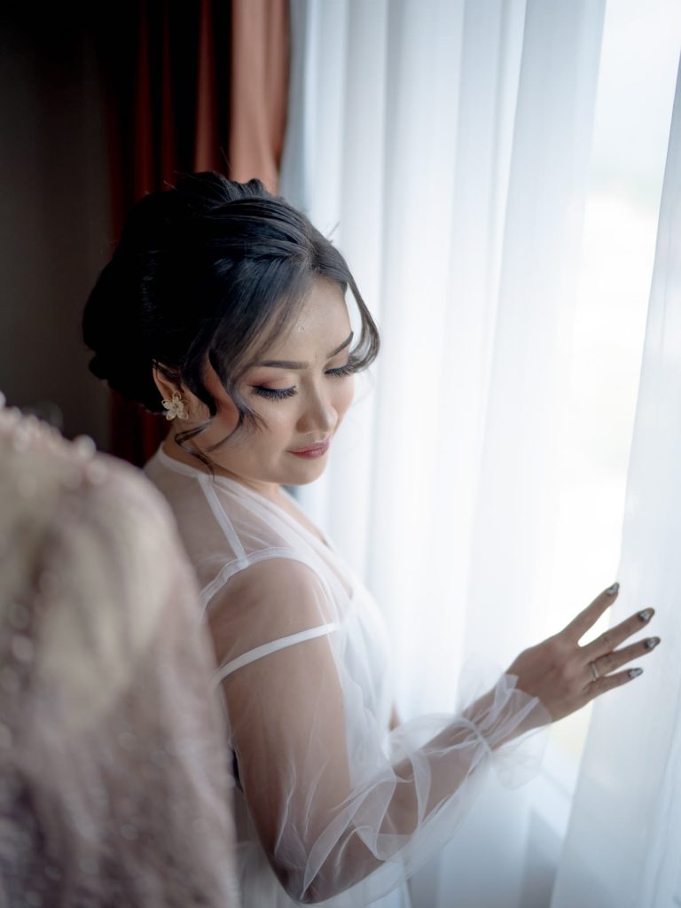 The bride by the window in soft light — Wedding, Lita & Danta