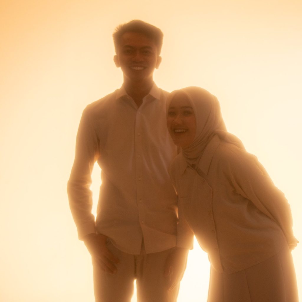 Silhouette against an orange backlight — Pre-wedding, Rere & Adit