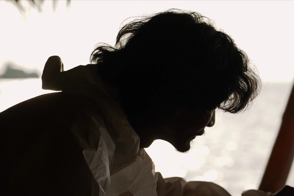 A character’s silhouette facing the sea — ZAKAR