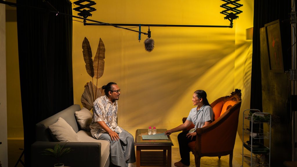 A yellow interior set with a lighting rig — Peaceful Local Elections short film series